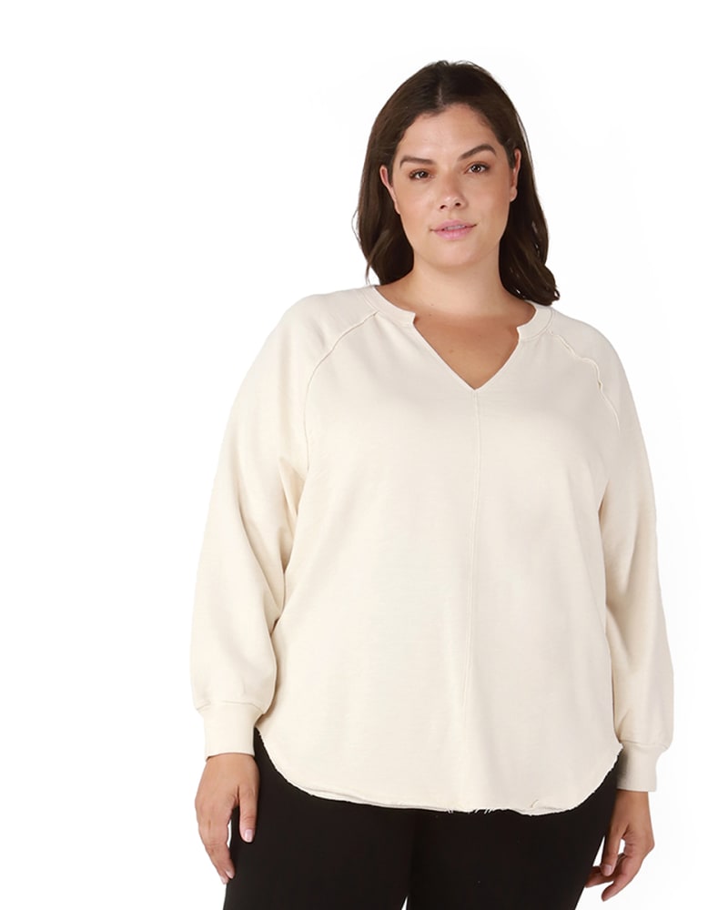 Front of a model wearing a size 0X Jaycie Raw Edge Hem Knit Top in Cream by DEX PLUS. | dia_product_style_image_id:235434